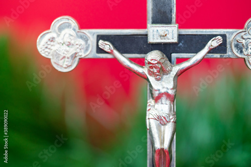 A silver figure of the crucified Jesus symbolizing Christmas. A symbol of sacrificing life for people.