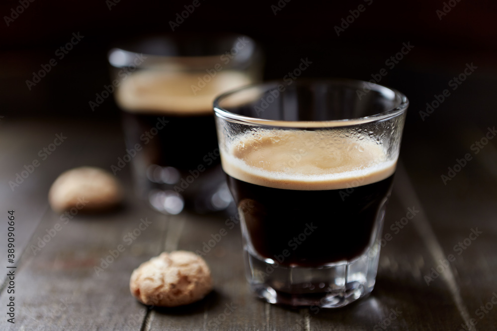 Two Glasses Of Coffee on dark wooden background. Close up. Two Glasses Of Coffee on dark wooden background. Close up.