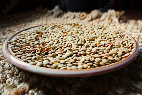 Bowl of green lentils on a rug photo