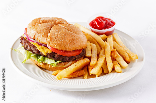 Cheeseburger with French fries and ketchup on a white background