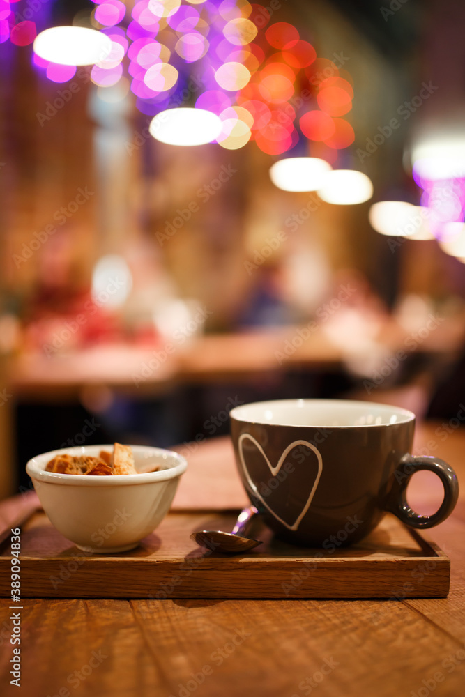 Fototapeta premium Serving cream soup in a cup with a cup of rusks on a wooden tray