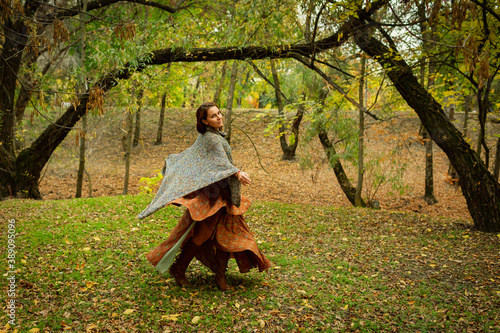 attractive woman whirls in the park in autumn © mishamif