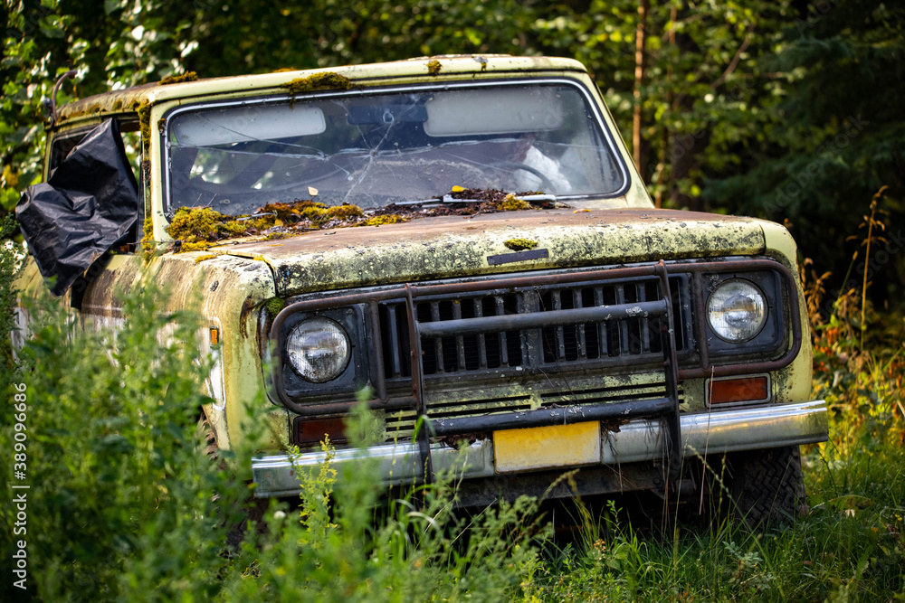 Classic old rusty 4x4 adventure truck in the forest