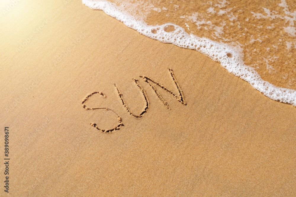 The inscription sun on the sea sand. vacation concept The inscription sun on the sea sand. vacation concept