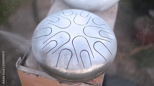 Making of a steel tongue drum. The process of painting and roasting photo