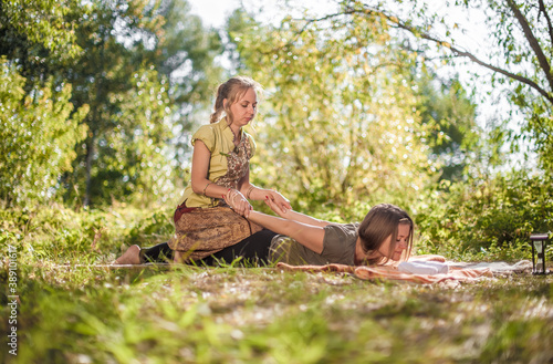 Girl on massage on the grass of the forest.
