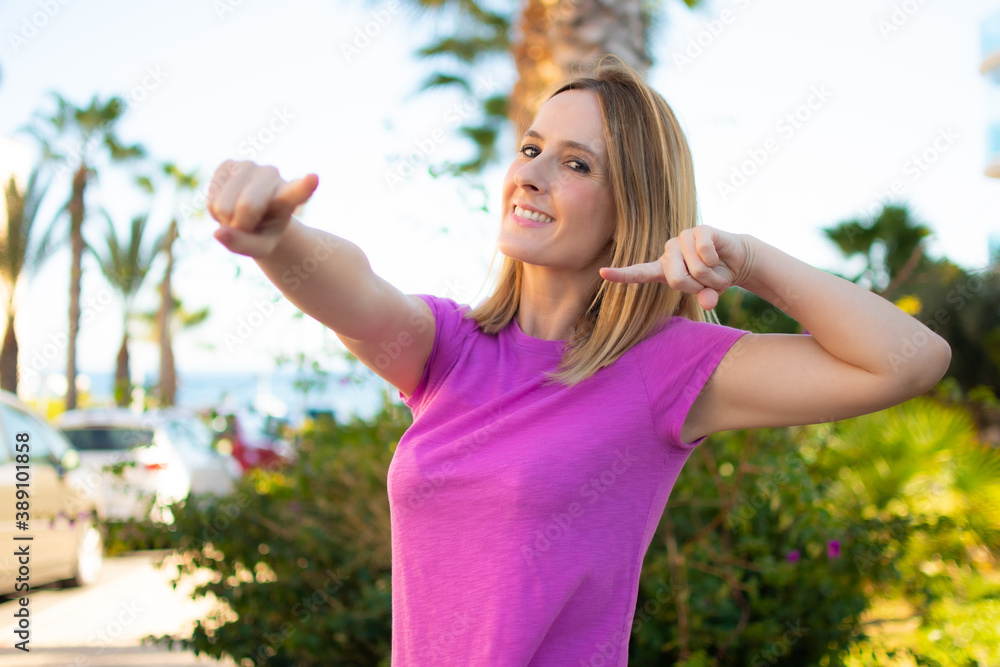 Attractive joyful young woman in pink t-shirt smiling over green background. Attractive joyful young woman in pink t-shirt smiling over green background.