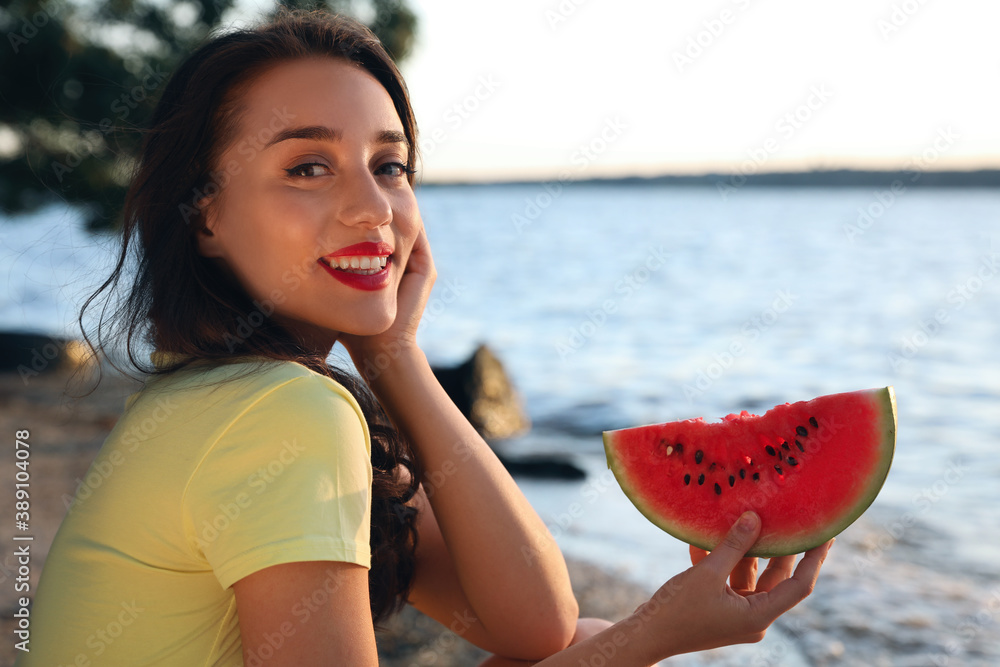 Beautiful young woman with watermelon near river - obrazy, fototapety, plakaty 