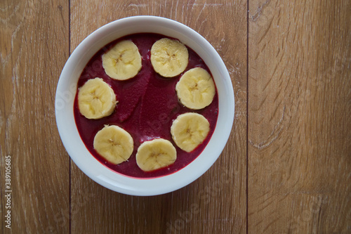 Top view of Brazilian açaí Bowl with bananas with copy space