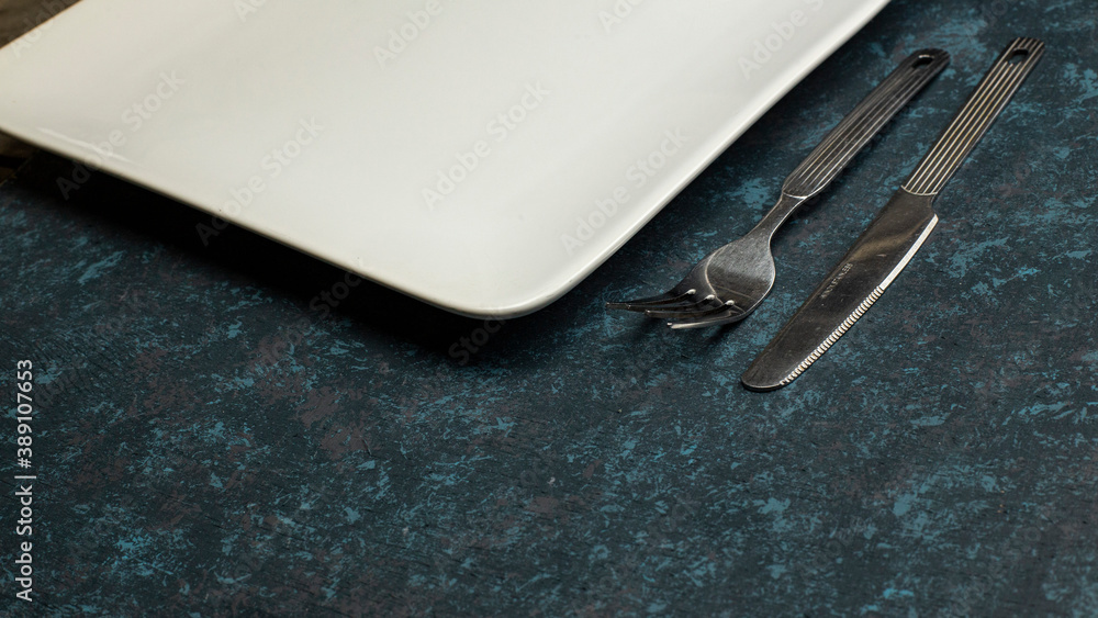 Cutlery knife and fork on textured table Cutlery knife and fork on textured table