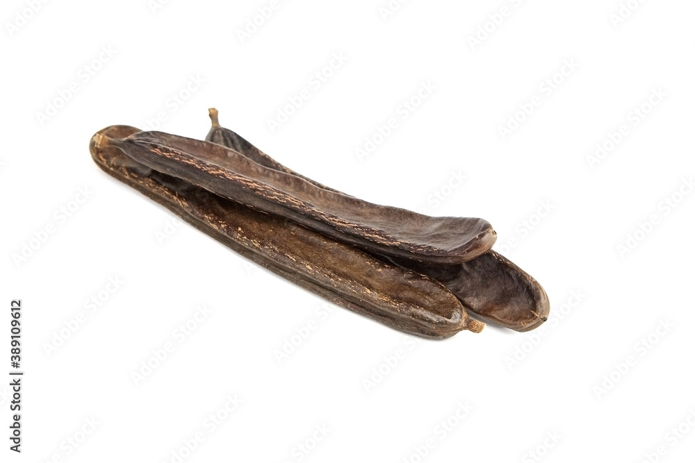 Dried carob tree fruits isolated on white background. Dried carob tree fruits isolated on white background.