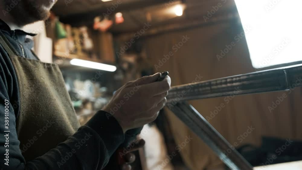 A man installs a nozzle in a screwdriver A man installs a nozzle in a screwdriver