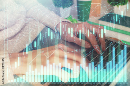 Double exposure of woman hands typing on computer and forex chart hologram drawing. Stock market invest concept. © peshkova