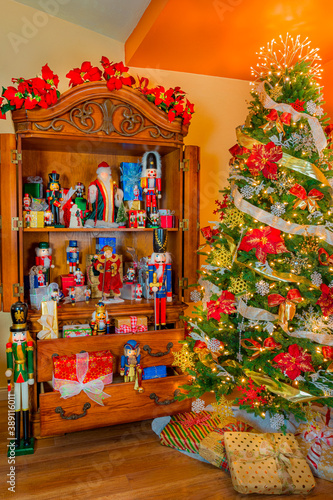 Christmas presents, nutcrackers and Santa Claus and a Christmas tree fill a room. © Patricia E. Thomas