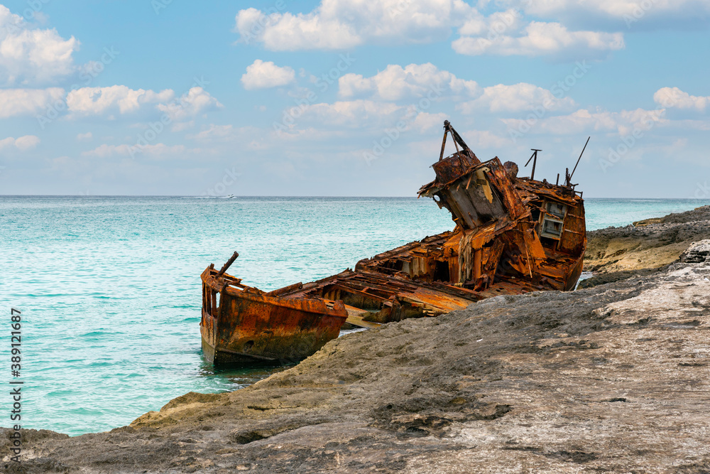 rusted shipwreck on the rocks of island