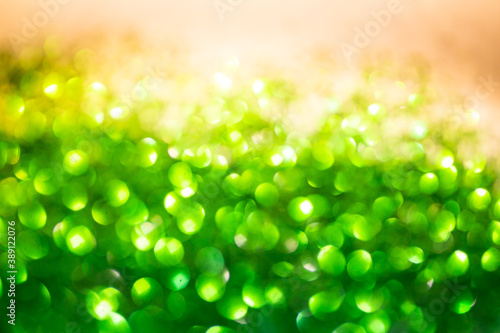 Green glitter vintage lights background defocused for festivals and celebrations