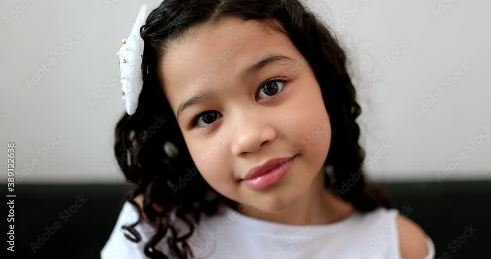 Ethnically diverse little child girl looking at camera portrait Ethnically diverse little child girl looking at camera portrait