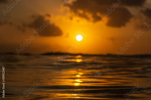 Golden sunset in tropical island Bali from the ocean.