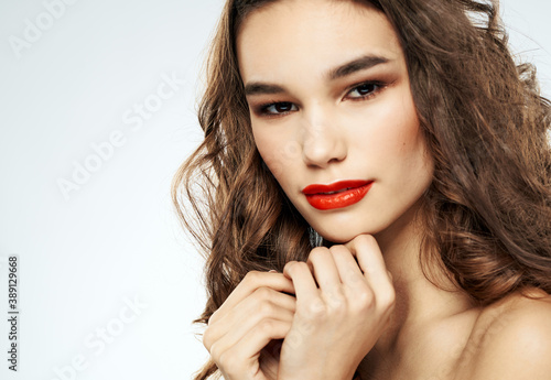 Woman with curly hair bright makeup portrait close-up and shadows on the eyelids