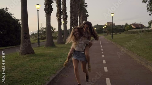 Slow motion shot of young woman giving a piggyback ride