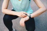Cropped shot of runner woman checking health status and fitness progress on her smart watch.