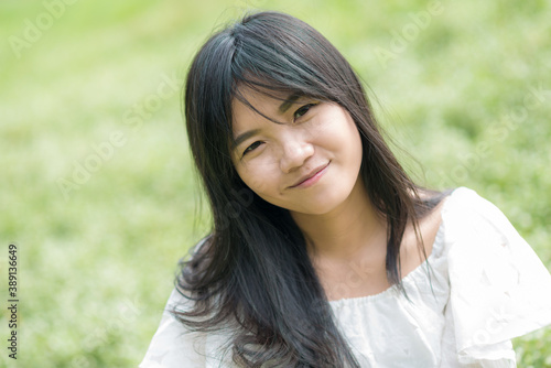 Fashion asian girl outdoor portrait walking in summer park and with long black hair