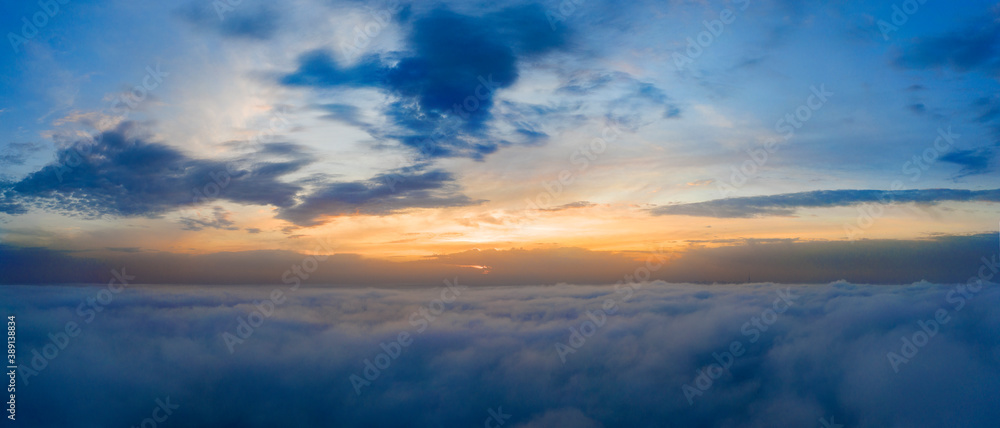 Dawn or sunset over the clouds, blue hour, aerial view.