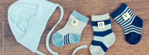 Blue socks and cap for baby with inscription boy, expecting for newborn concept