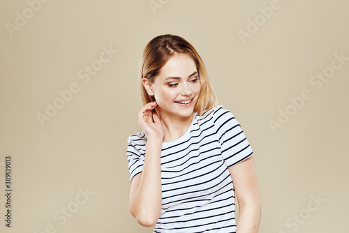 Cute blonde striped t-shirt smile lifestyle beige studio background