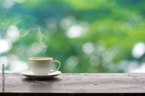 Close up coffee espresso on wood table raining background in garden,