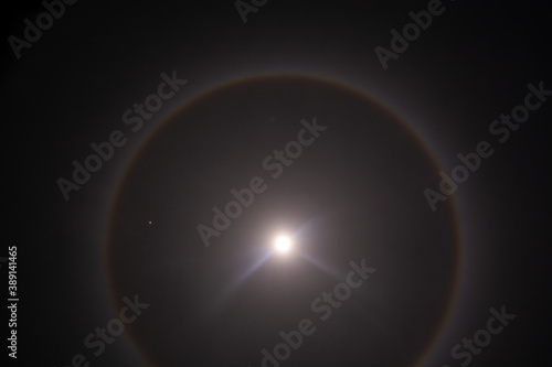Full moon with a halo of light and very close the planet Mars, lunar rainbow with the blue moon