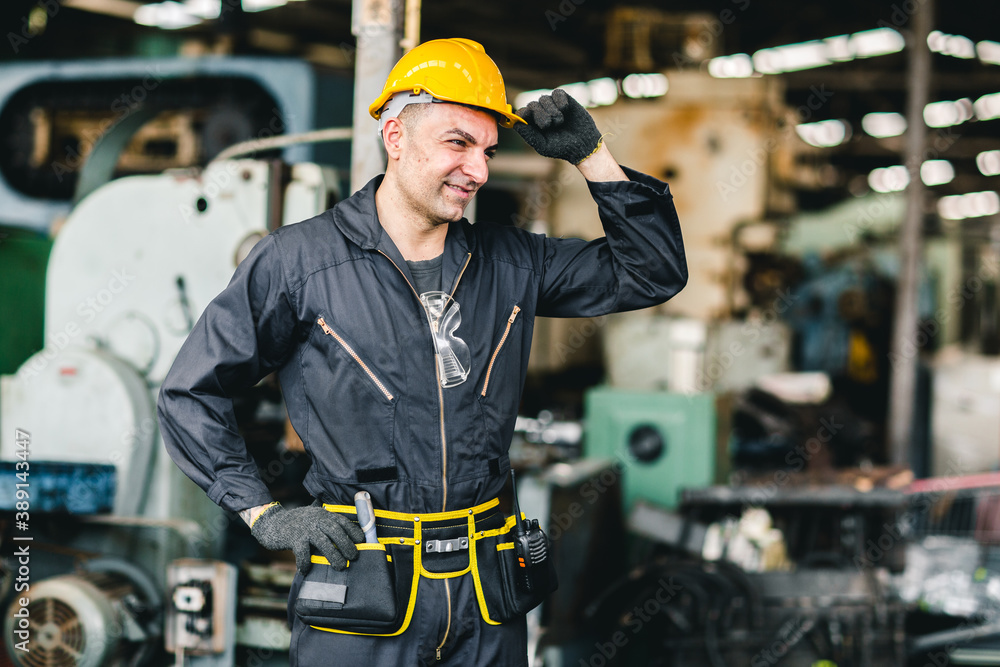smart handsome European Russian worker happy working in factory with yellow helmet and safety suit portrait standing at heavy industry workplace. smart handsome European Russian worker happy working in factory with yellow helmet and safety suit portrait standing at heavy industry workplace.