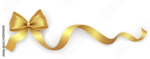 Decorative gold bow with ribbon on a white background. Holiday decoration design element for packaging, gift box, postcard, banner.