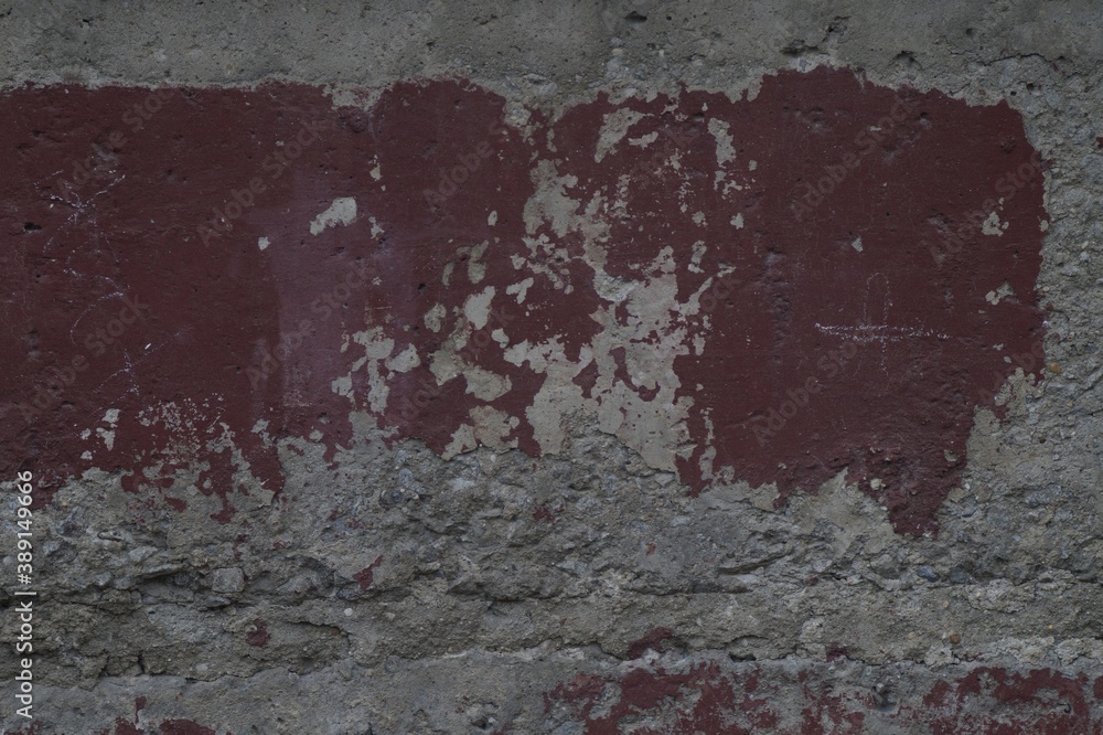 Obraz premium Photo of an old texture wall. The paint was crumbling. Cracks, fractures, and dents. In shades of grey and red Bordeaux.