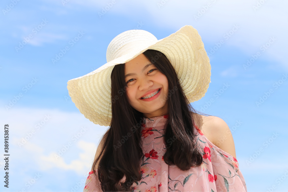 Beautiful asian girl are smiling with bluesky. Asian woman with braces smiling.