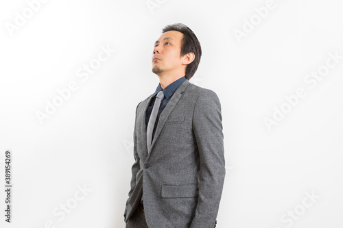 Successful Asian business man in suit and tie with confidence gesture on white background.