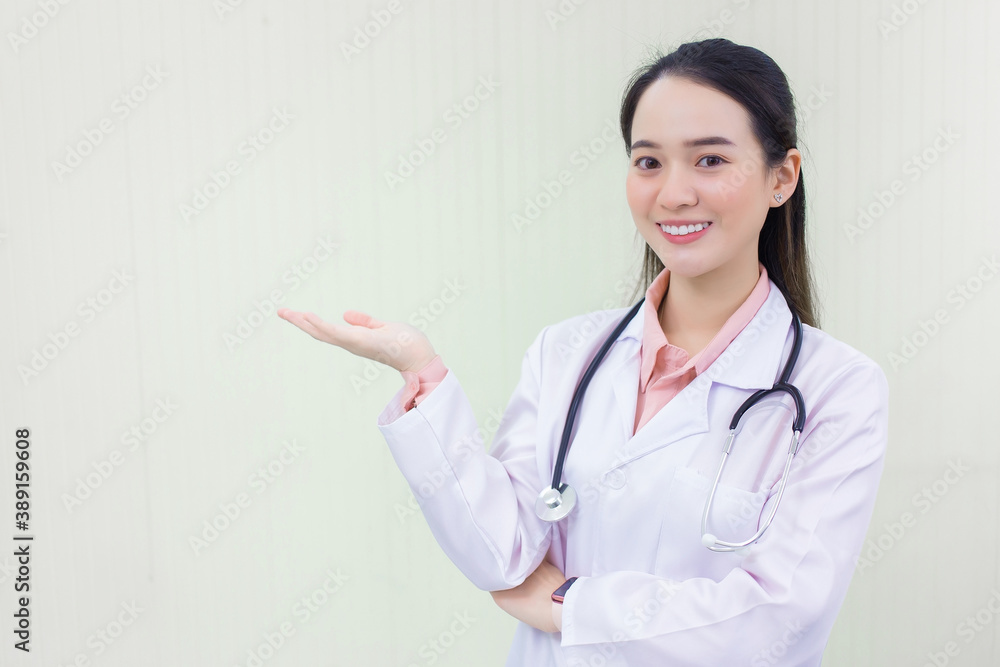 Asian woman doctor shows her hand to present something on white background. Asian woman doctor shows her hand to present something on white background.