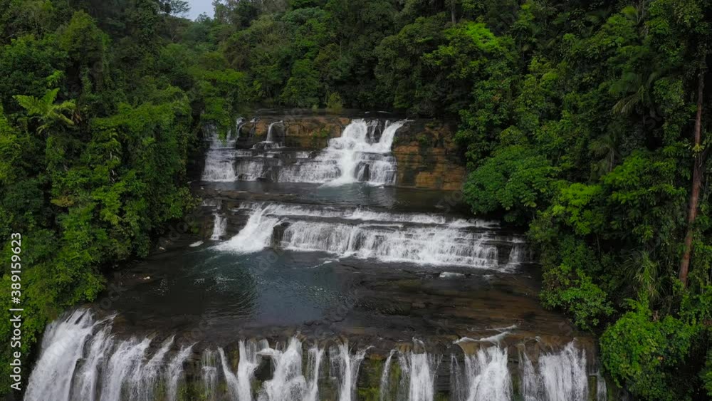 Waterfall in the green forest. Tinuy-an Falls in the jungle, island of Mindanao, Philippines. Waterfall in the green forest. Tinuy-an Falls in the jungle, island of Mindanao, Philippines.
