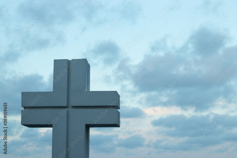 Religious Christian cross against the sky with copy space. Faith and religion concept illustration