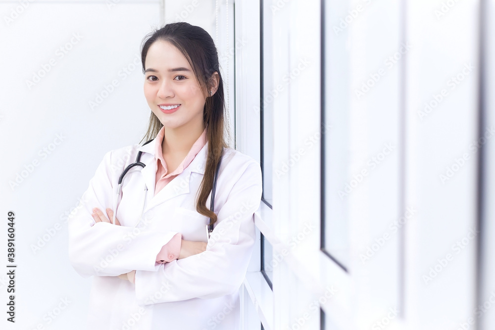 Asian female doctor with black long hair wears a white lab coat and stethoscope. Asian female doctor with black long hair wears a white lab coat and stethoscope.
