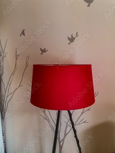 Abstract pictures from the home.  Red lamp with artistic background of birds and tress painting  photo