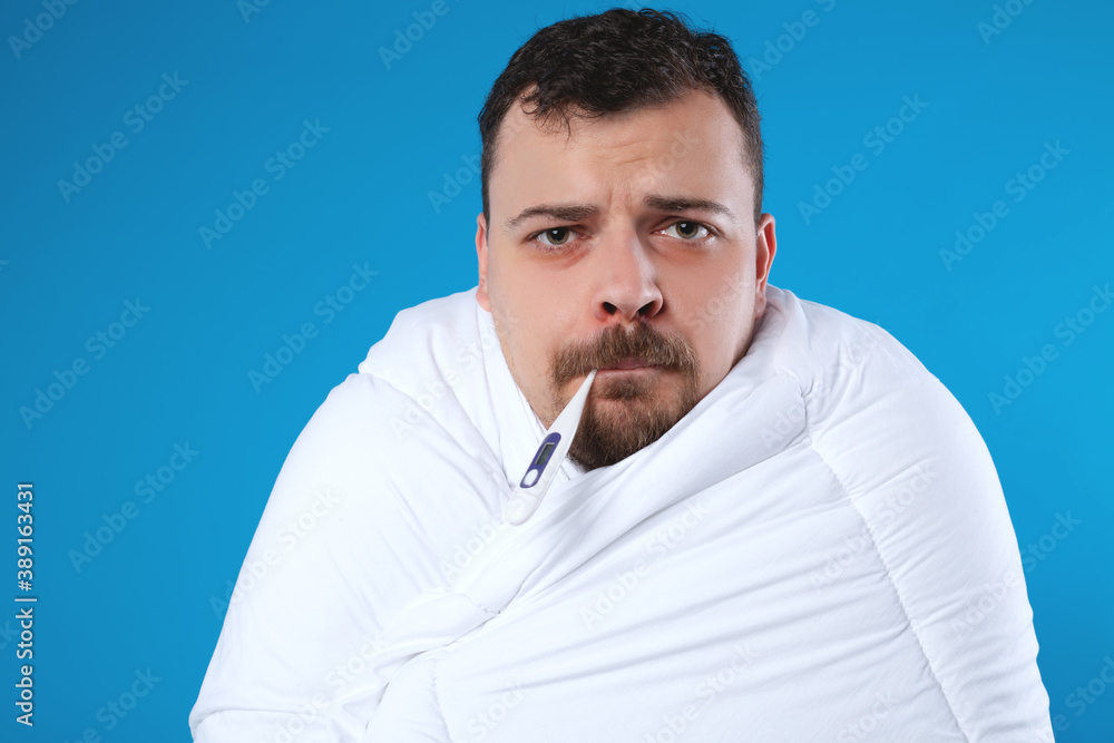 Sick man wrapped in a blanket Sick man wrapped in a blanket