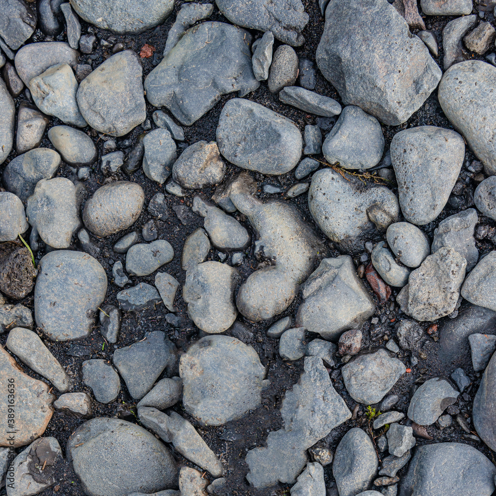 Round river pebbles as a background and texture, closeup, details. Round river pebbles as a background and texture, closeup, details.