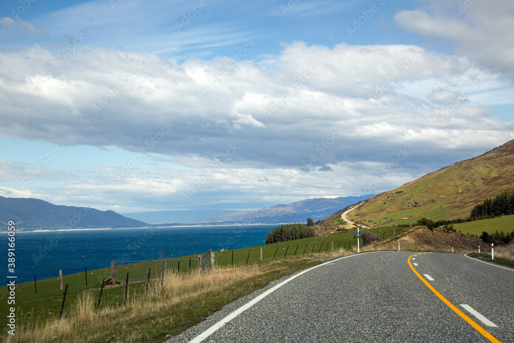 Road trip past Lake Hawea on the South Island New Zealand - no cars on an empty road.