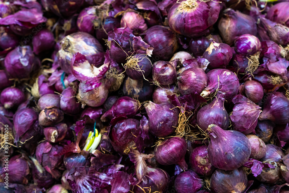 Red onion heads. Lots of onions. The frame is filled with red onions