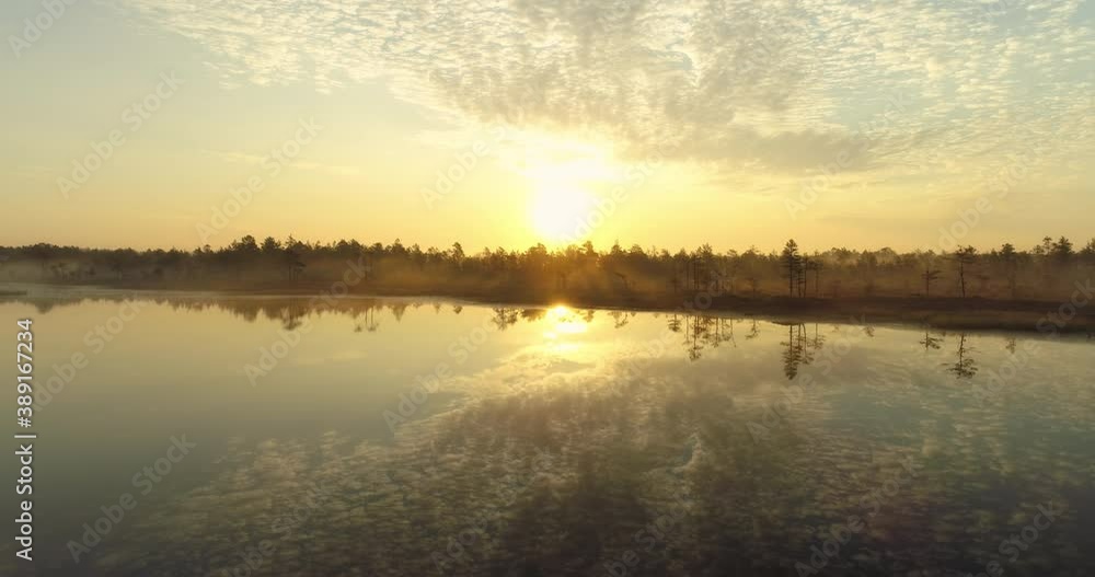 Sunrise over misty bog lake and forest landscape aerial view Sunrise over misty bog lake and forest landscape aerial view