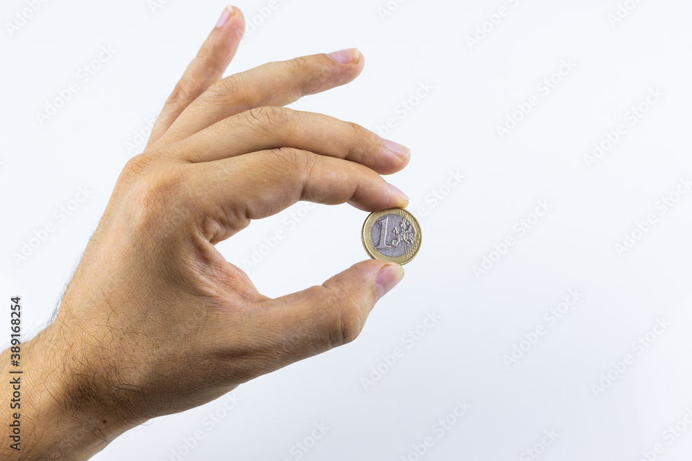 hand on a white background holding coins hand on a white background holding coins