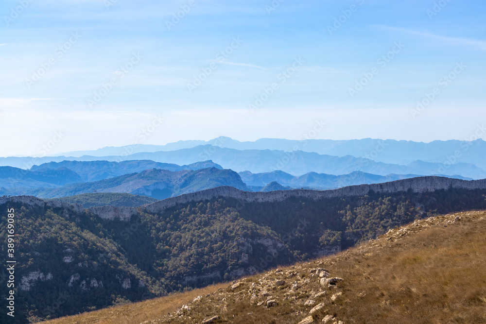 Typical mountain ranges at summer time. Blue landscape, sunny day with no one on the picture. Dry weather by the Mediterranean sea. Mountain layers. Serra de Llaberia, Tarragona, Catalonia, Spain