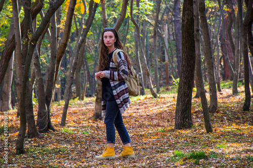 Beautiful woman in autumn and fall forest and wild, autumn tree with yellow and red leaves © taidundua