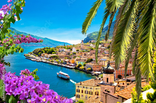 Limone sul Garda waterfront viewthrough flowers and palm tree photo